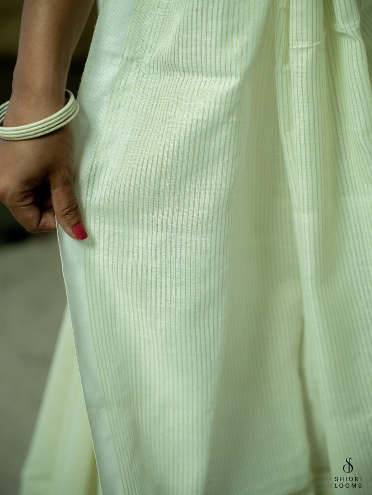 Handwoven white Cotton saree with gold zari stripes