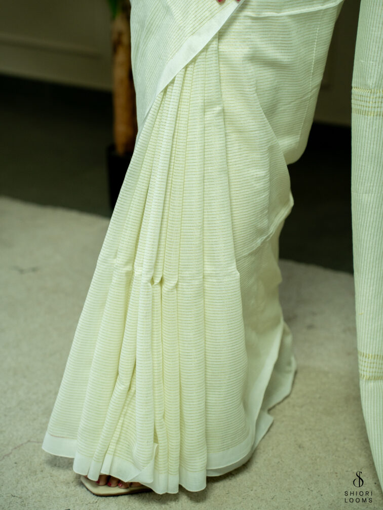 Handwoven white Cotton saree with gold zari stripes