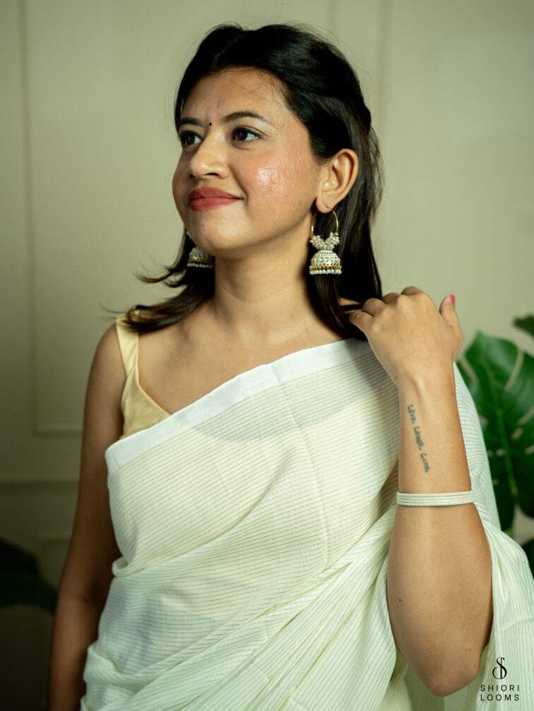 Handwoven white Cotton saree with gold zari stripes